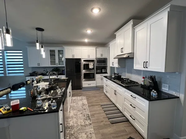 Two-tone kitchen with granite countertops and gas range by WoodArt Cabinets San Antonio