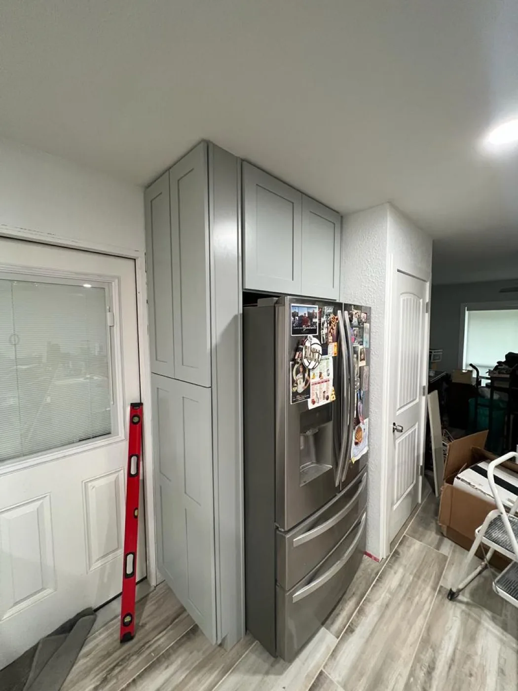 Quality laundry and utility room cabinets in San Antonio TX — folding stations, tall pantry, and sink base by WoodArt