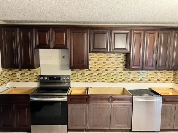 Dark cabinets with mosaic backsplash by WoodArt Cabinets San Antonio