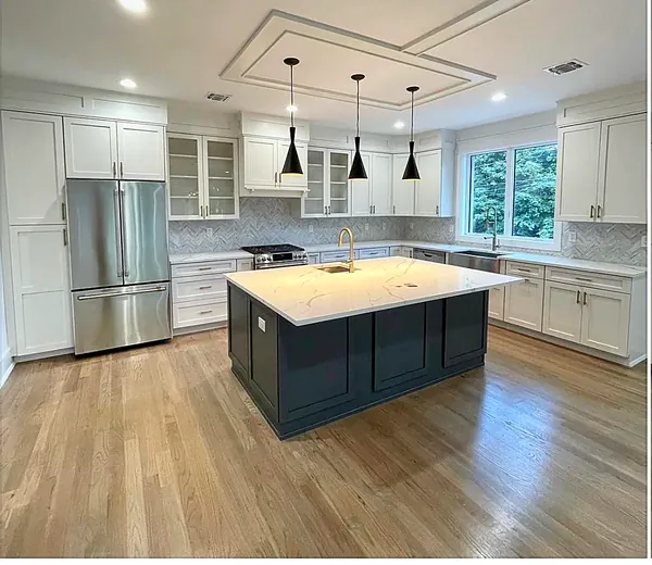 white kitchen with navy island and glass-front upper cabinets by WoodArt Cabinets San Antonio