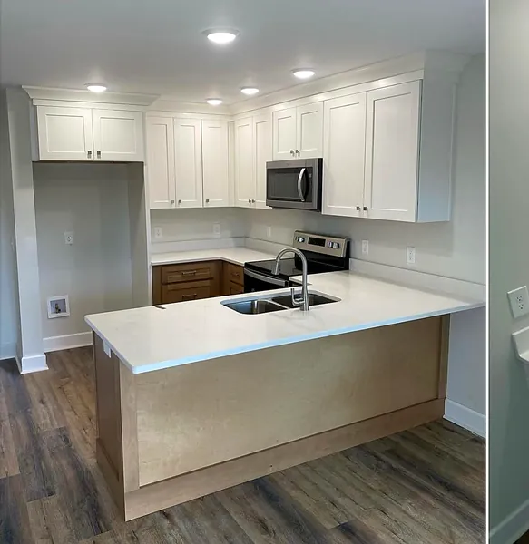 white kitchen with peninsula and quartz countertop by WoodArt Cabinets San Antonio